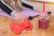 Two red dumbbell and smoothie in retro jar on floor and woman working stretching exercises