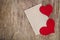 Two Red fabric hearts with sheet of paper