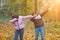 Two red-haired dancing girls on the background of autumn nature, the concept of human emotions