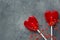 Two Red Heart Shape Candy Lollipops on Sticks Flowers on Dark Stone Background. Valentine Romantic Love Greeting Card