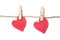 Two red hearts on clothespins on white background - Valentine`s day concept