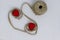 Two red hearts connected by jute twine wound on a ball. Valentine`s Day. White background. The concept of love, wedding