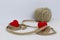 Two red hearts connected by jute twine wound on a ball. Valentine`s Day. White background. The concept of love, wedding