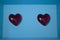 two red hearts on each side of a blue background