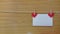 Two red hearts hanging on a line on wooden table. Copy space