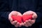 Two red hearts held male hands