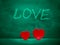 Two red hearts side by side and chalk sign love in the background. Saint Valentine abstract background