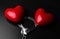 Two red hearts and steel handcuffs on dark background.St Valentine day and Fifty shade of black concept
