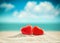 Two red hearts on the summer beach. Valentines day.