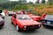 Two red italian lancia sports cars at angle riding back to back
