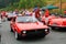 Two red italian lancia sports cars riding back to back