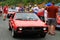 Two red italian lancia sports cars riding back to back