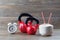 Two red kettlebells with coconut and clock on walnut wood