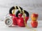 Two red kettlebells with measuring tape, apples, and clock