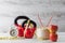 Two red kettlebells with measuring tape, drinking coconut, apple