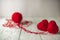 Two red knitted hearts and a ball of yarn