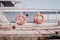 Two red lifebuoys hanging on touristic boat