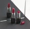 Two red lipsticks, perfect versus imperfect symbolic concept ide