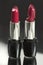 Two red lipsticks, perfect versus imperfect symbolic concept ide