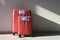 Two red luggages with protective masks