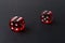 Two red playing dices on black table. Luck and fortune concept