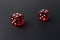 Two red playing dices on black table. Luck and fortune concept