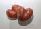 Two red potatoes in the shape of hearts isolated on a white background. Heart shaped potato isolated on white paper. The concept