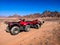 Two red quads stand near the mountains in the South Sinai desert near Sharm El Sheikh Egypt. ATV safari concept, active leisure