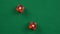 Two red roll dices and stops on the table with double 1 in slow motion.