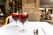 Two red sangria glasses on white tablecloth in restaurant