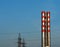 Two red stripy industrial chimneys background