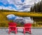 Two red sun loungers for tourists on the lake