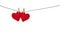 Two red valentine hearts hanging from a rope fixed by clothespins isolated on white background