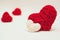 Two red and white clews in shape of heart made from yarn