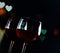 Two red wine glasses on hearts decoration bokeh lights background