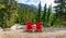 Two red wooden chairs with a view on the mountains in Glacier National park, Rocky Mountains, Bristish Columbia Canada