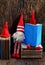 Two red woolen gnome busy with  notebook, cute Christmas ornament for winter time decoration