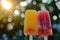 Two refreshing fruit popsicles with a sunlit background