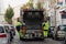 Two refuse collection workers loading garbage into waste truck emptying containers