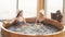 Two relaxing caucasian girl enjoying jacuzzi in hotel spa