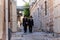 Two religious Jews walk and talk down the street near Jaffa Gate in the old city of Jerusalem, Israel