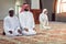 Two religious muslim man praying together inside the mosque