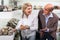 Two retirees together choosing pair of shoes in fashion store