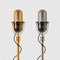 Two retro microphones - golden and chromium, on a checkered background.