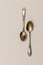 Two retro silver teaspoons on a light background