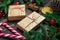 Two retro-style gifts with a red twine and candy cane surrounded by spruce branches close-up