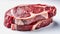Two rib eye steaks one on top of another on white background. Raw beef meat