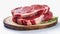 Two rib eye steaks one on top of another on white background. Raw beef meat on wooden board