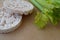 Two rice white round bread with fresh green stem celery healthy food organic product