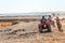 Two riders on quad ATVs in the Sahara Desert.